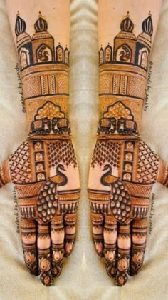 two hands with henna designs on them