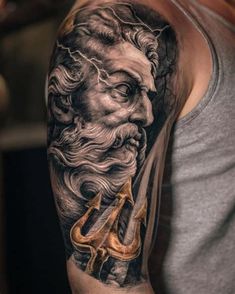 a man's arm with a black and white tattoo on it, depicting an old man