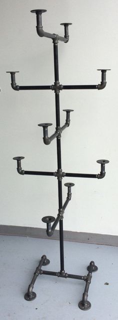 a tall metal candelabra with multiple candles on it's sides and four lights in the middle