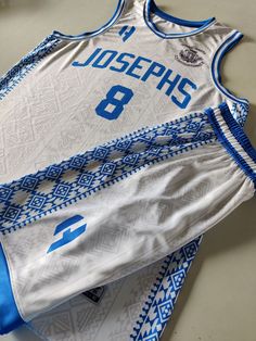 a basketball jersey with the number 8 on it sitting on top of a table next to other items