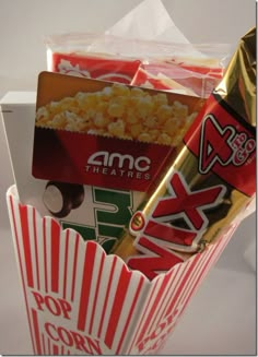 a popcorn box filled with different types of snacks