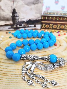 ✔️ This Blue rosary made by using 10 mm blue turquoise stone beads. ✔️ 10 mm big size tasbeeh  ✔️ Blue turquoise stone tesbih  ✔️ High grade round cut beads  ✔️ This elegant tasbih is a very special gift for your loved ones. ✔️  PLEASE CLICK THE LINK FOR ALL PRAYER BEADS MODELS         https://www.etsy.com/shop/GoodJewelsofYazmasal Note: As a natural feature the stones beads may have some variations. Metal aparats (imam, tassel,spacers) may be different from the photo due to stock position. If y Traditional Blue Jewelry With 8mm Beads, Turquoise Rosary With Round Beads, Spiritual Turquoise Rosary With Round Beads, Turquoise Rosary With Round Beads As Gift, Blue Rosary, Turquoise Howlite, Bleu Turquoise, Love Blue, Labradorite Stone