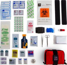 the contents of an emergency kit laid out on a white surface, including medical supplies