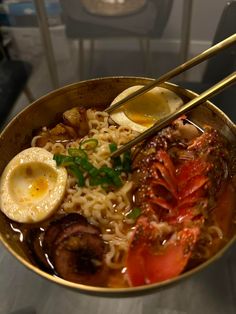 a bowl of ramen with chopsticks and boiled egg on the side, in front of a glass table