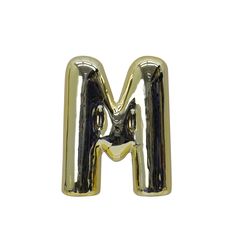 the letter m is made out of gold foil and it looks like an inflatable balloon