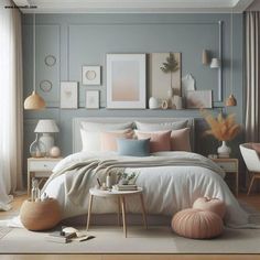 a bedroom decorated in pastel colors with pictures on the wall and bed linens