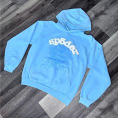 Brand New Size M Blue Glitter Sweater, Blue Sp5der Hoodie, Blue Hooded Sweatshirt For Streetwear, Light Blue Graphic Print Sweatshirt For Winter, Sporty Light Blue Hoodie For Streetwear, Winter Light Blue Graphic Sweatshirt, Blue Hoodie With Drawstring For Streetwear, Blue Graphic Print Hoodie For Fall, Blue Adjustable Hood Sweatshirt For Streetwear