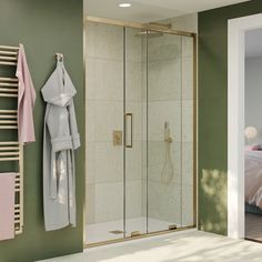 a bathroom with a walk in shower next to a towel rack