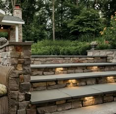 an outdoor patio with stone steps and lighting