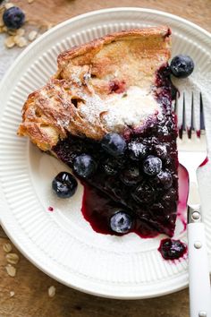 a piece of pie on a plate with blueberries