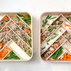 two trays filled with food sitting on top of a white counter next to each other