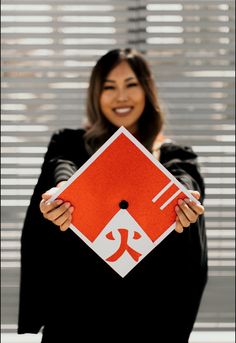 a woman holding up a red and white sign