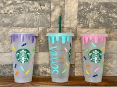 three starbucks cups with sprinkles on them