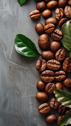 some coffee beans and leaves on a table