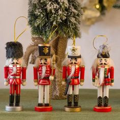 three nutcrackers are standing next to a potted plant