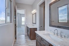 a large bathroom with double sinks and mirrors