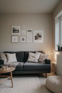 a living room filled with furniture and pictures on the wall