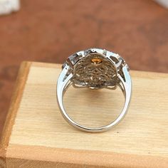 Vintage, Art Deco 14KT white gold round, center citrine and diamond filigree design ring. Size 6.25 Can be resized for an additional fee Weight: 5.80 grams Stone measures: 3.5mm Stamped 14K & hallmarked .50 ct natural diamonds; I1-2/ H-J Very Good Condition Low profile setting White Gold Topaz Ring With Diamond Accents, Round Citrine Diamond Ring With Brilliant Cut, Brilliant Cut Citrine Diamond Ring, Elegant Orange Topaz Round Ring, Luxury Filigree Ring With Gemstone, Topaz Filigree Round Ring, Saint Jewelry, Citrine Ring, Filigree Design