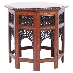 an ornate wooden table with marble top and carved carvings on the sides, isolated against a white background