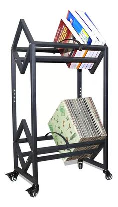 a metal rack with books and magazines on it's wheels is shown in front of a white background