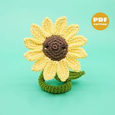 a crocheted sunflower on a green background