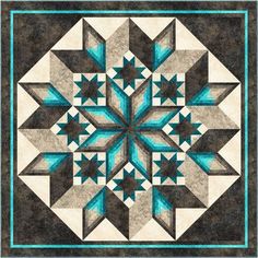 a blue and black quilt with an intricate design on it's center piece, which is