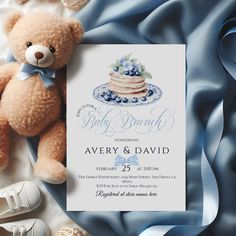 a teddy bear sitting next to a baby shower card