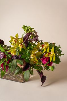 a vase filled with lots of flowers on top of a table