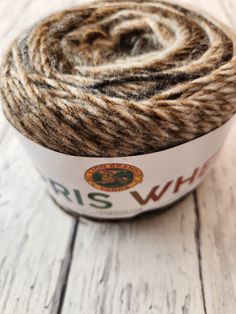 a skein of yarn sitting on top of a white wooden floor