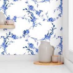 blue and white floral wallpaper in a kitchen with two vases on the counter