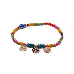 The Colorful Beaded Yogi Ankle Bracelet is adorned with bronze gold-plated Om-Dream and Heal charms. The Om symbol represents the divine and the unity of all things, while the Dream and Heal charms symbolize the power of dreams and the potential for personal transformation and healing. These handmade charms serve as gentle reminders to embrace the power of intention and self-care. This unique anklet features carefully selected elements that come together to create a harmonious and meaningful des The Om Symbol, Power Of Dreams, The Power Of Intention, Power Of Intention, Meaningful Design, Personal Transformation, Om Symbol, June Birthstone Jewelry, Manifest Your Dreams