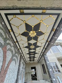 the ceiling is decorated with gold and black designs, along with scaffolding on the walls