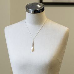 One of a kindHandmade in Seattle Unique long oval baroque pearl with smaller white and pale grey pearls on polished silver chain Materials: solid sterling silver fresh water pearls Measurements: Adjustable necklace chain: 17" - 19" Pendant area: 2 5/8" long x 3/8" wide Comfortable - Adjustable length fits varying necklines and light weight makes it easy to wear Timeless - pearls never go out of style High Quality - all chain connections are welded and pearls/gems are tightly wire wrapped, custom Silver Necklace With Oval Pearl Charm Pendant, Silver Oval Pearl Drop Necklace, Silver Oval Necklace With Pearl Drop, Silver Oval Pearl Necklace, Sterling Silver Oval Pearl Drop Necklace, Silver Oval Pearl Necklaces, Silver Baroque Pearl Briolette Necklace, Oval Silver Pearl Necklace, German Jewelry