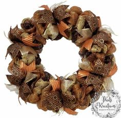 a gold and brown wreath with ribbons on it