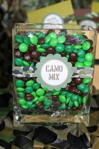 a glass container filled with green and brown candies