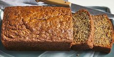 a loaf of bread sitting on top of a blue plate with a knife next to it