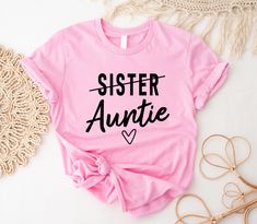 Sister To Auntie Shirt, Aunt T-Shirt, Gift For Auntie, Pregnancy Announcement Shirt, Aunt Gift, Auntie Reveal Shirt, Auntie Sweatshirt Welcome to BelinayShirt,  Your ultimate destination for unique and stylish printed t-shirts! At BelinayShirt, we believe in expressing individuality through fashion. Our collection features a wide range of designs, from trendy graphics and bold statements to artistic prints and personalized options. Each shirt is crafted with high-quality materials to ensure comfort and durability. Whether you're looking to make a fashion statement or find the perfect gift, BelinayShirt has something for everyone. Discover your new favorite tee today and wear your personality with pride! Auntie Pregnancy Announcement, Trendy Graphics, Aunt T Shirts, Auntie Shirts, New Aunt, Pregnancy Announcement Shirt, Aunt Gifts, Printed T Shirts, Apparel Design