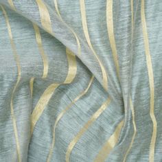 a close up view of a blue and gold striped fabric