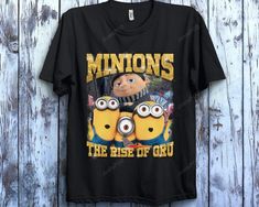 Peckshirt Despicable Me Minions Gru Shirt The Rise Of Gru T-Shirt, Unisex T-Shirt Adult Tee Toddler Shirt Kid T-Shirt - Print In Your Way. Upgrade your wardrobe with this high-quality shirt. This painstakingly made item provides the ideal balance of comfort and design. It radiates classic elegance and is sufficiently versatile for both casual and business attire. This shirt is made from premium materials and is sure to leave an impact. This must-have addition to your wardrobe will make a big imp Funny Fan Merchandise Tops With Character Print, Funny Character Print Tops For Fans, Funny Character Print Tops For Fan Merchandise, Funny Fan Merchandise Tops With Sublimation Print, Funny Tops With Sublimation Print For Fans, Minions The Rise Of Gru, Rise Of Gru, Despicable Me Minions, The Minions