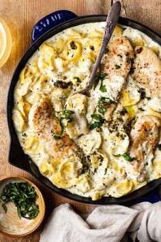 a skillet filled with pasta and chicken