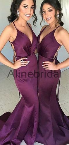 two women standing next to each other in purple dresses