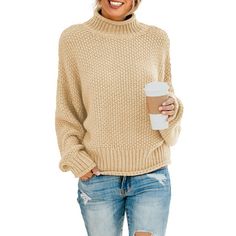 a woman wearing ripped jeans and a white sweater holding a coffee cup in her hand