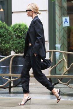 a woman walking down the street in heels