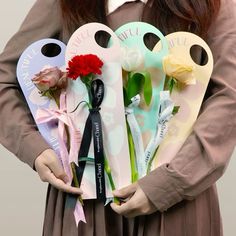 a woman is holding flowers and keys in her hands