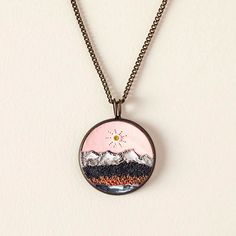 National Park Sculpture Necklace | Love Nature | Uncommon Goods Pnw Necklace, Park Sculpture, Hand Painted Nature-inspired Pendant Necklace, Nature-inspired Resin Round Pendant Necklaces, Time Stands Still, Nature-inspired Resin Pendant Necklace, Uncommon Goods, Clay Sculptures, Necklace Love