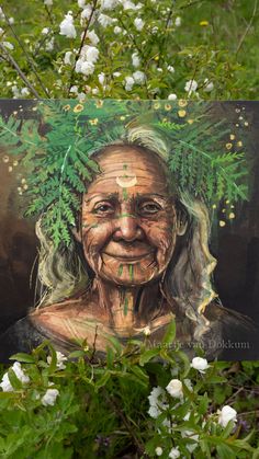 an old woman with green leaves on her head and face is surrounded by white flowers