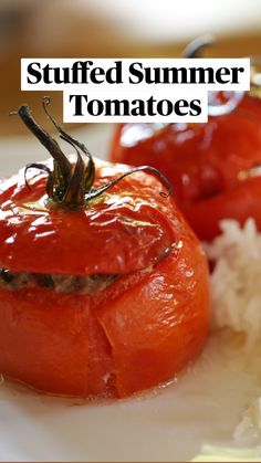 two tomatoes and rice on a white plate