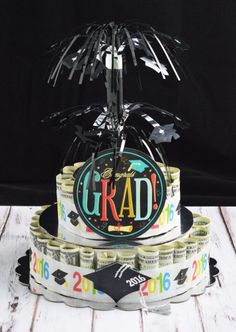 the graduation cake is decorated with black and white confetti, streamers, and starbursts