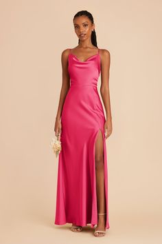 a woman wearing a pink dress with a slit