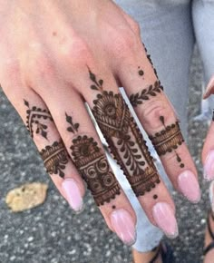 two hands with henna tattoos on them